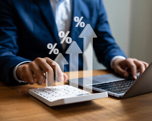 Businessman using calculator and laptop with increasing percentage arrows graphic overlay