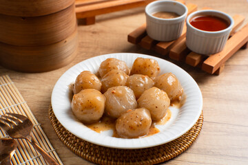 Cilok is a snack made from tapioca flour and served with savory and spicy peanut sauce. Perfect for recipes, articles or any cooking content.