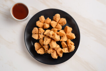 Indonesian Snack Food. Bakso Goreng or Deep Fried Meatball. Made from Chicken, Meat, or Shrimp with Flour. Served with Spicy Sauce. Perfect for recipes, articles or any cooking content.