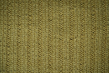 mustard texture of knitted fabric, macro texture of yellow wool fabric, geometric knitted pattern...