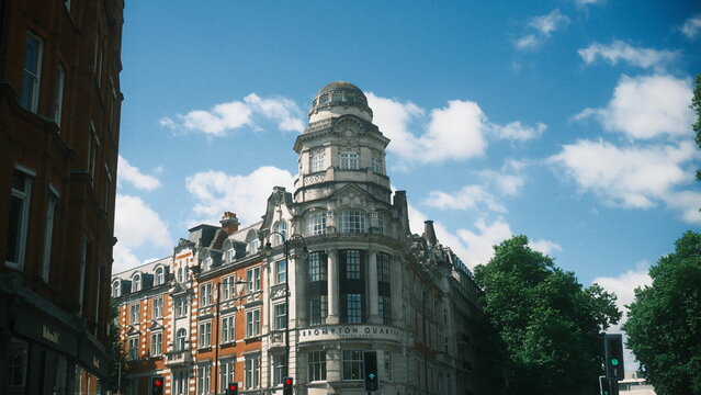 A highly detailed, professional photograph of a building with a clock on the top of it captured with artistic lighting and excellent composition. the scene features under calm and cool conditions.