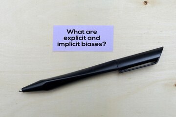 Paper book with the question words What are explicit and implicit biases?