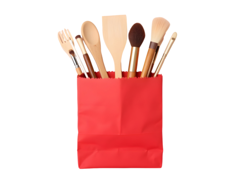 Culinary Essentials in Red: A charming arrangement of cooking and baking utensils peeks out of a vibrant red paper bag, showcasing essential tools. PNG file
