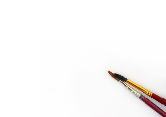 Paint brushes on white paper