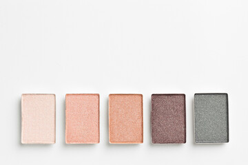 Beautiful eyeshadow refill pans on white background, flat lay. Space for text