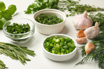 Different herbs and spices on white table, closeup