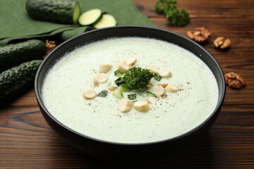 Tasty cucumber soup with croutons and broccoli on wooden table, closeup