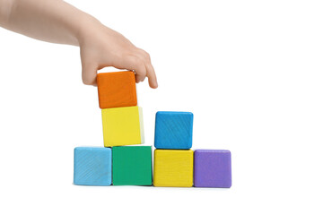 Child playing with colorful cubes on white background, closeup