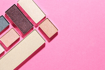 Beautiful eyeshadow refill pans on pink background, flat lay. Space for text