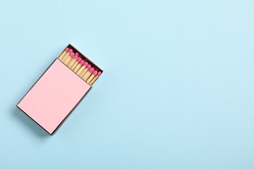 Matches in box on light blue background, top view. Mockup for design