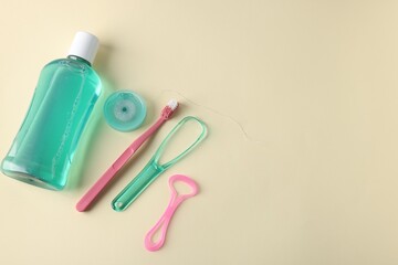 Different oral care products on beige background, flat lay. Space for text