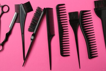 Different hairdresser's tools on pink background, flat lay