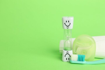 Different oral care products on green background. Space for text