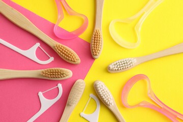 Toothbrushes, tongue cleaners and floss picks on color background, flat lay