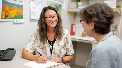 Obraz premium A manager discusses strategies with an EAP specialist to enhance support services for employees. They review insights and notes in a friendly, collaborative atmosphere