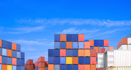 Cargo Container Stack Pile in International Industry Port Terminal Shipment Yard against Blue Sky Background at Commercial Harbor, Export and Import logistics Shipping Transportation Backdrop