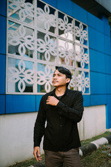 Fototapeta premium Thoughtful Young Man Contemplating Future Aspirations near Modern Building