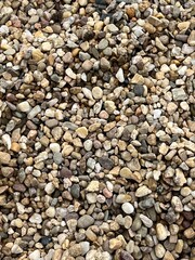 Pebbles texture, pattern with irregular shaped gray beige natural tones, rocks and stones for garden path, construction and walkway design