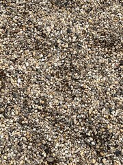 Pebbles, fine texture, pattern with irregular shaped gray beige natural tones, rocks and stones for garden path, construction and walkway design