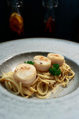 close up of a plate of pasta with scallops inside
