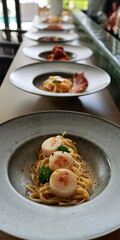 close up of alignment of plates on a counter  with pasta inside