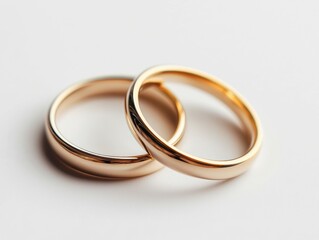 Two golden wedding rings interlocking, symbolizing love and commitment