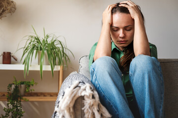 Female person suffering from headache and mental health problems