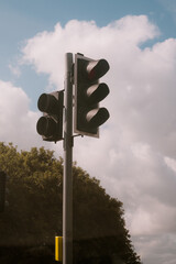 Traffic lights on M1 road, with a blue sky and cloud in the background.