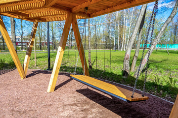 Wooden modern bench in the park. Landscape design