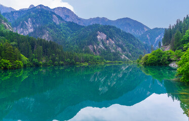 Beautiful view of the Five Flower Lake (Multicolored Lake) among fall woods in Jiuzhaigou nature reserve (Jiuzhai Valley National Park), China.