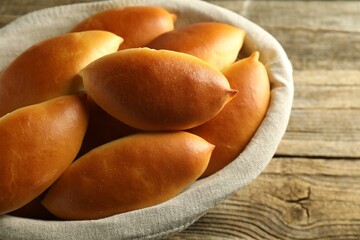 Tasty baked patties on wooden table, closeup