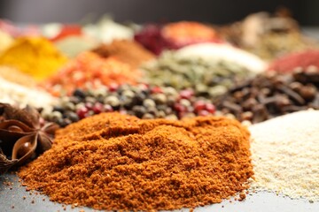 Different aromatic spices on grey table, closeup