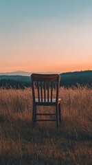 Wooden chair in the middle of a field at dusk.