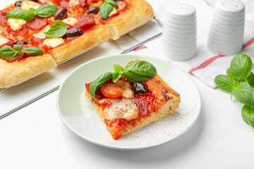 Tasty homemade pizza on white wooden table, closeup