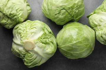 Fototapeta premium Fresh green cabbages on grey table, flat lay