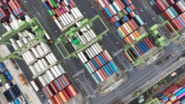 Drone shot of modern industrial container port of Singapore with containers from top view. It is an import and export cargo port where is a part of shipping dock
