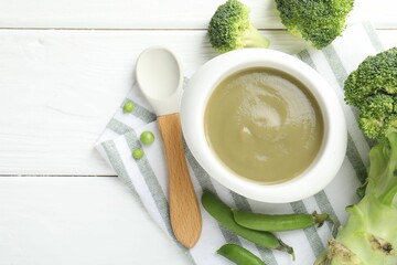 Baby food. Tasty puree in bowl, spoon and ingredients on white wooden table, flat lay. Space for...