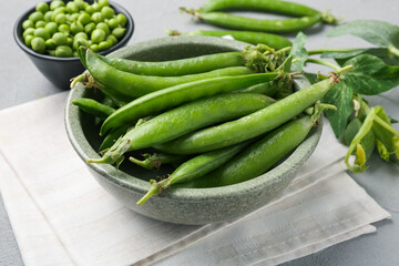 Fresh ripe green peas on grey table, closeup
