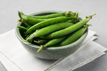 Fresh ripe green peas on grey table, closeup