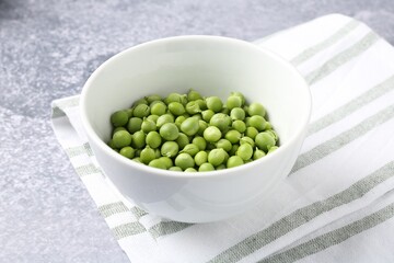 Fresh ripe green peas on grey table, closeup