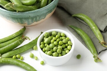 Fresh ripe green peas on white wooden table, closeup