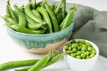 Fresh ripe green peas on white wooden table, closeup
