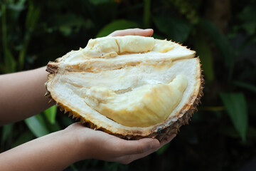 Woman with fresh ripe durian outdoors, closeup