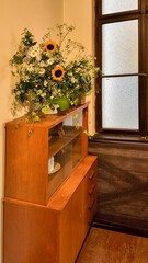 A bouquet of wildflowers in a vase. Wildflowers in an old house. A bouquet of wildflowers and sunflowers. A concept of old times and romance