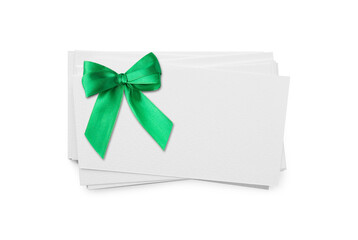 Blank gift card with green bow on white background, above view. Mockup for design