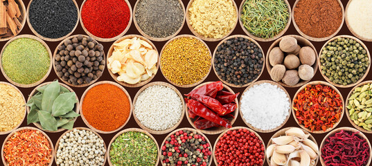 Set of different aromatic spices in bowls on black background, flat lay. Banner design