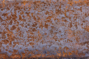 Rough rusty metal surface with significant corrosion outdoors