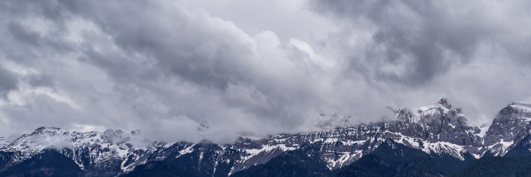 Majestic Serra del Cadi mountains with spring snow and dramatic clouds