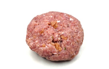 Closeup view of a raw patty (Bifteki in Greek), round and flat, made from beef meat, isolated on a white background, ready for cooking or preparation.