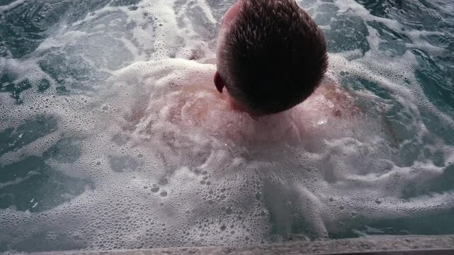 Man in a jacuzzi pool.